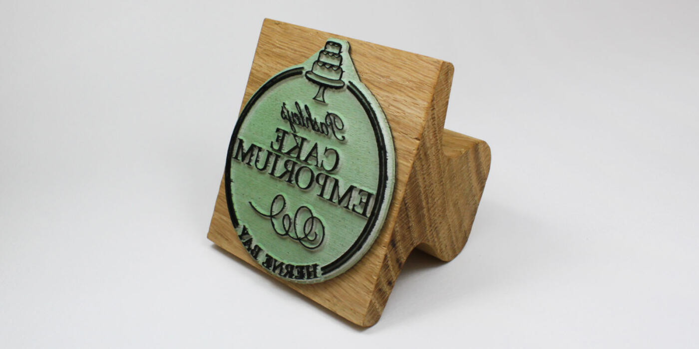 custom stamp made from green eco rubber and oak